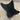 Black butterfly chair on a wooden floor