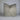 Gray textured pillow on a white surface