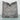 Gray pillow with geometric pattern on a light blue surface