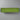 Green cylindrical pillow on a reflective surface with a white background